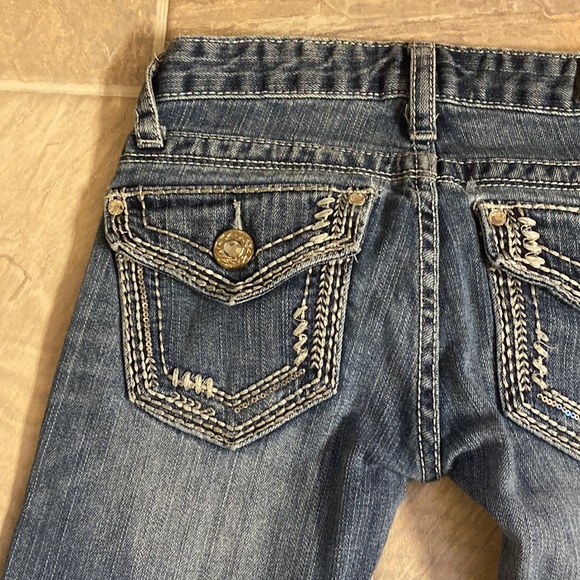 Low cut, boot cut jeans.  Small wear in pocket.  Shown in pictures - Picture 5 of 9